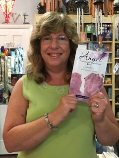 Author, Maria G. Maas holding her book, ANGEL PRACTITIONER HANDBOOK: A Foundation Guide